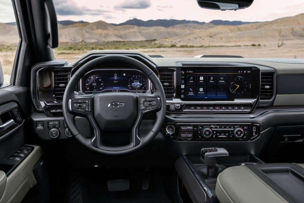 Front-facing view of the 2024 Silverado ZR2’s interior showing the steering wheel and center console.