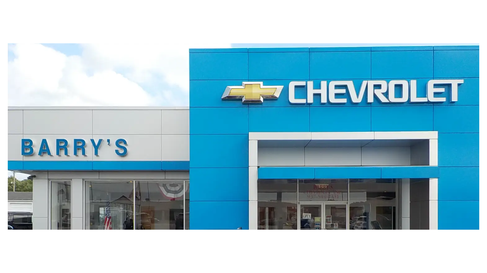 A family walking towards a Chevrolet vehicle in the driveway.