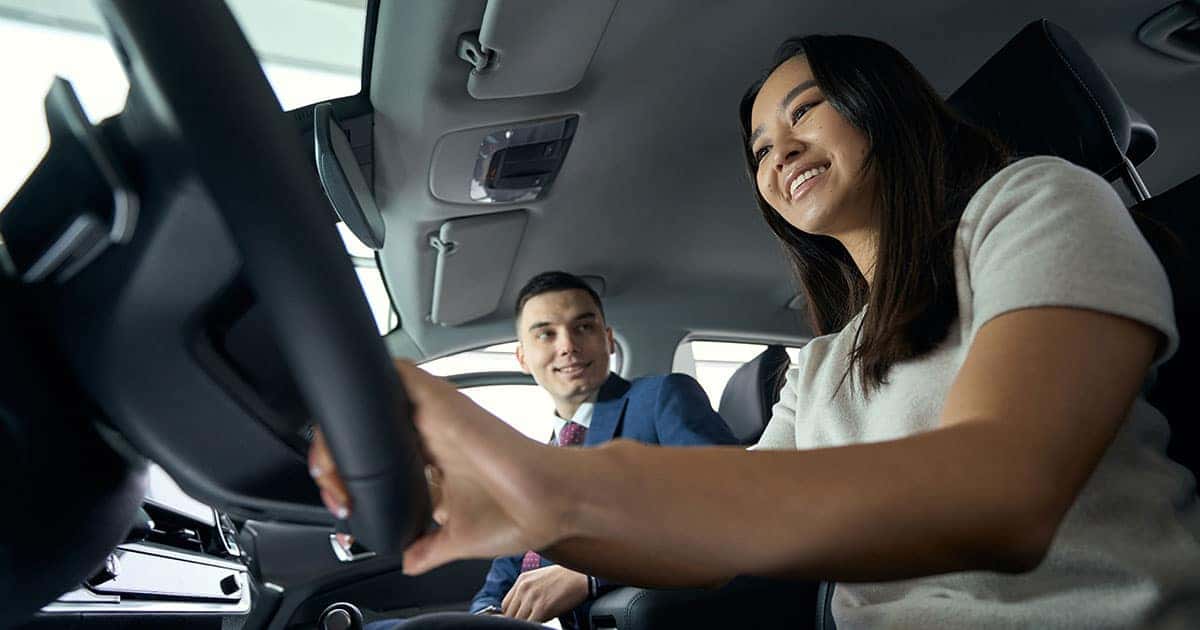 woman driving a car with the sales agent