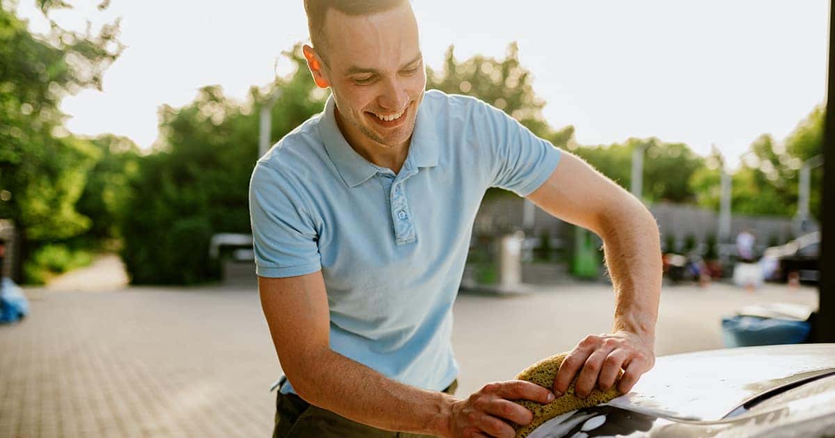 man cleaning his car