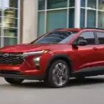 2026 Chevrolet Trax Apex Red driving in a city