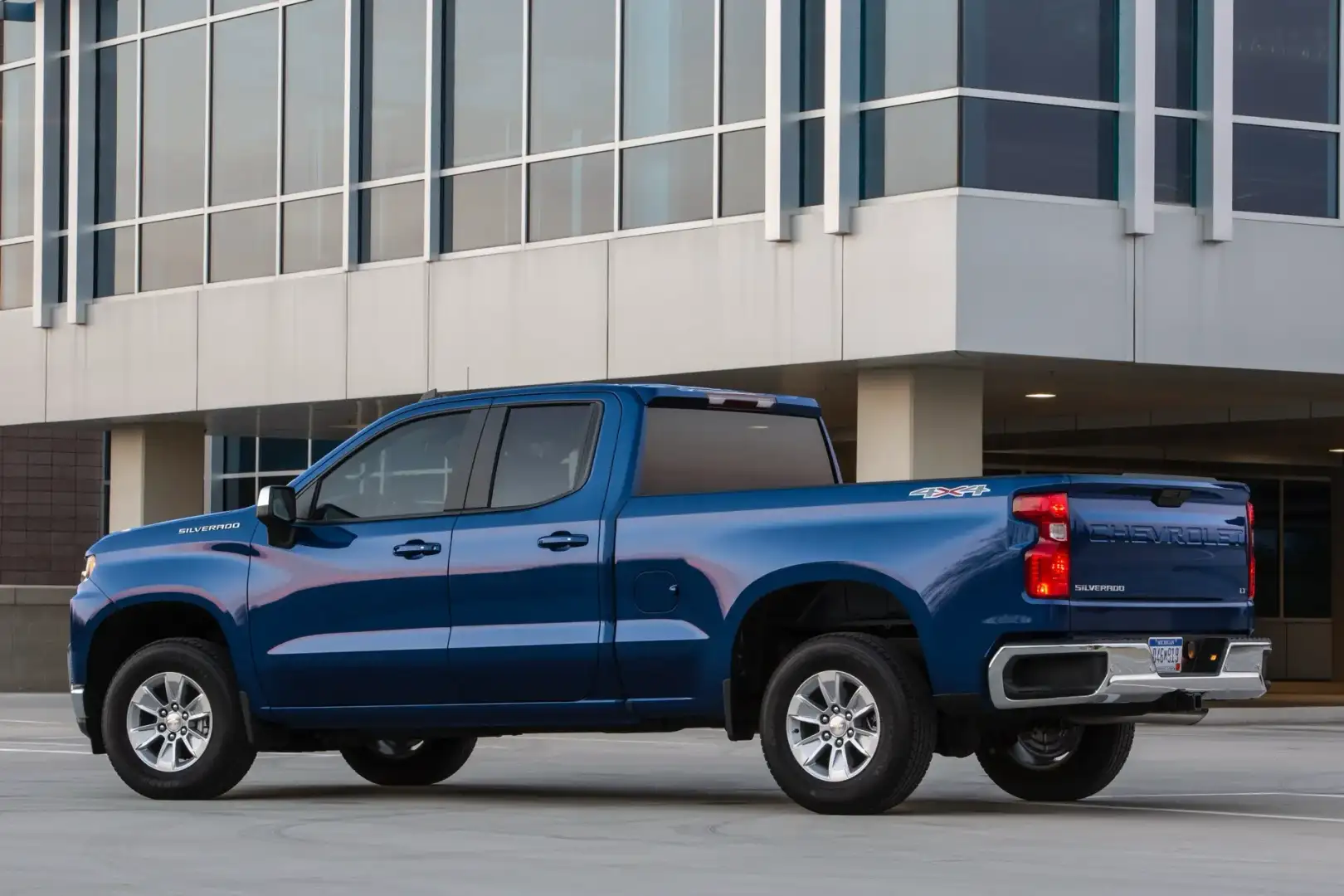 Blue Chevrolet Silverado parked in front of a building