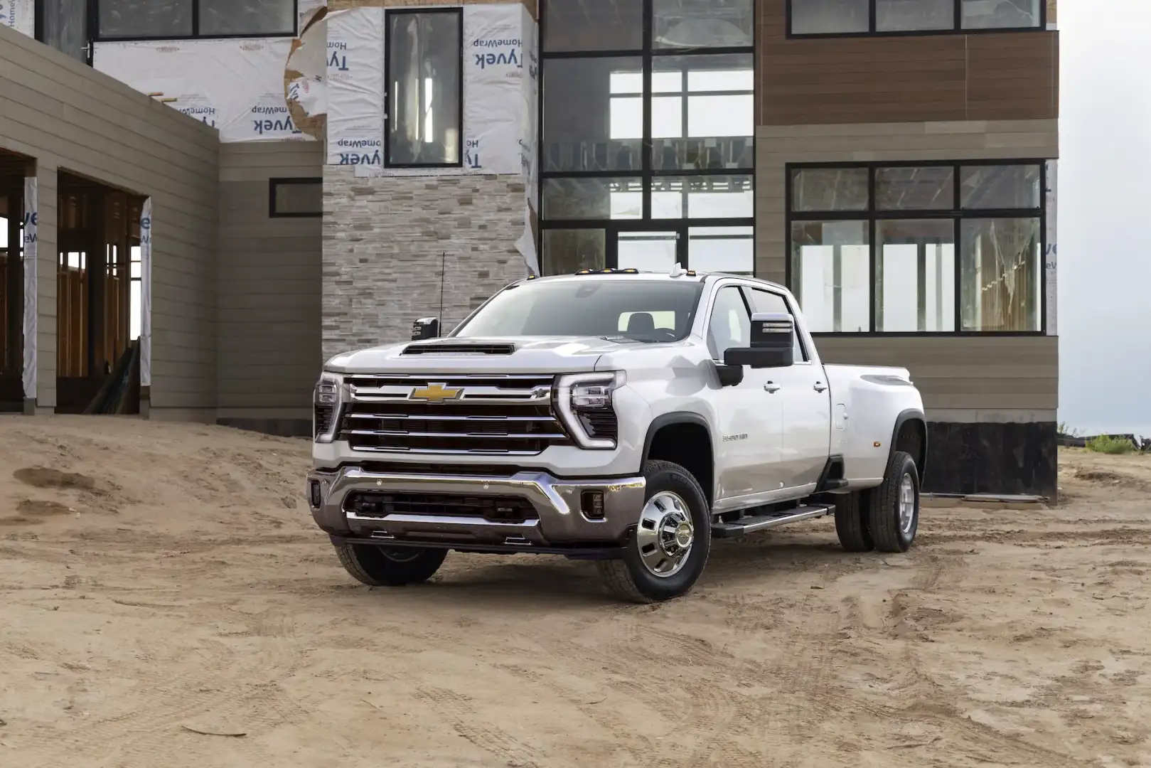 White Chevrolet Silverado 3500HD High Country parked in front of a house being built