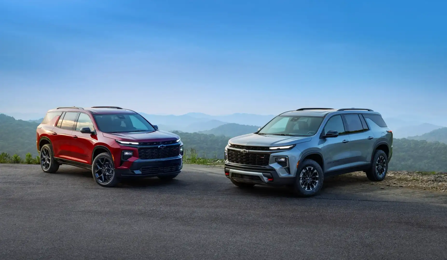 Red and Silver Chevrolet Traverse parked off road on a mountain