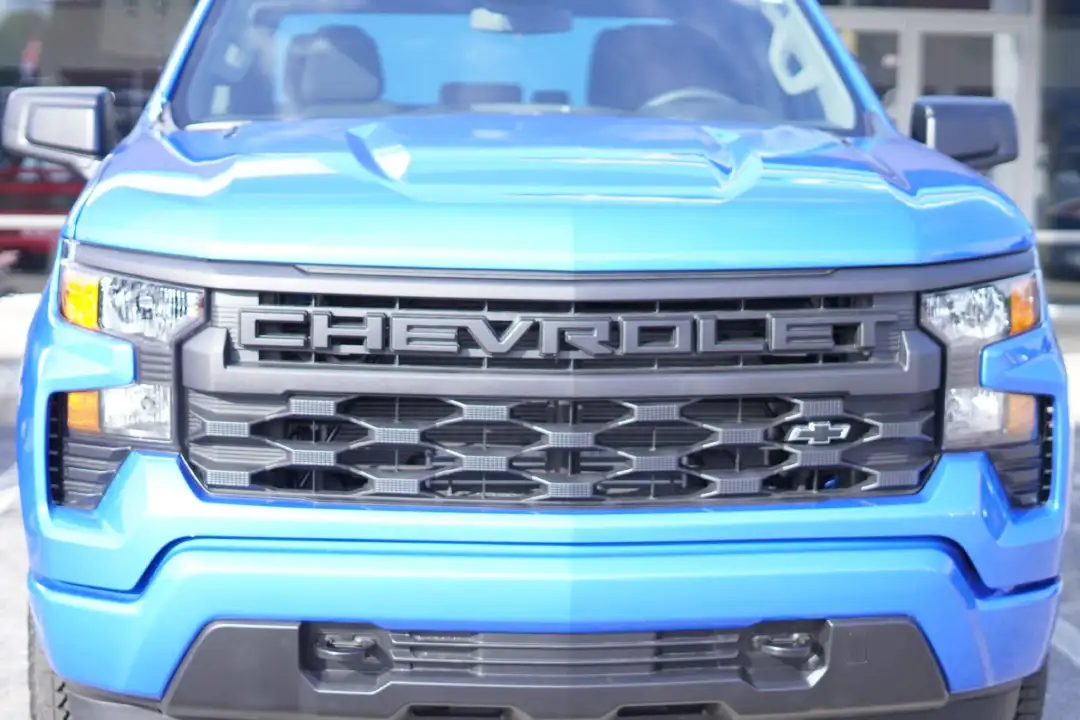 Front close-up view of a bright blue Chevrolet Silverado truck at Barry's Chevrolet in West Union, OH