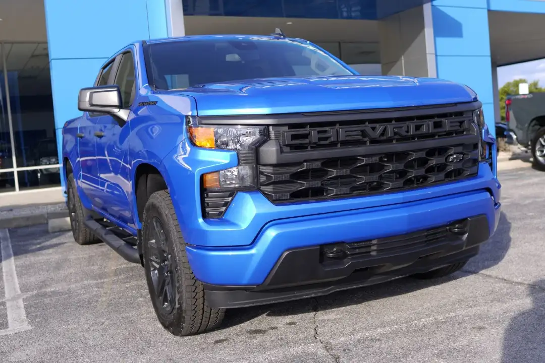 Low-angle front view of a bright blue Chevrolet Silverado 1500 Custom truck at Barry's Chevrolet in West Union, OH
