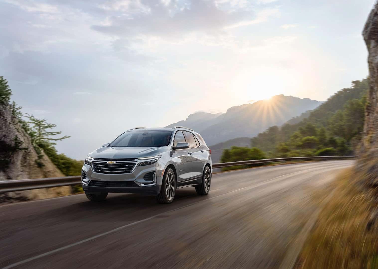The Fabulous 2023 Chevrolet Equinox Riding Away As The Sun Rises Above A Magnificent Mountain