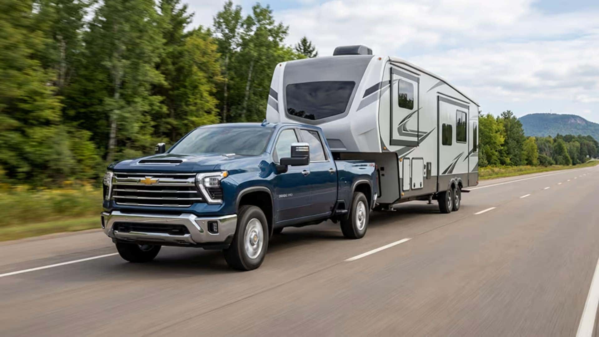 The All=Powerful 2026 Chevrolet Silverado Towing A Trailer On The Highway With Ease
