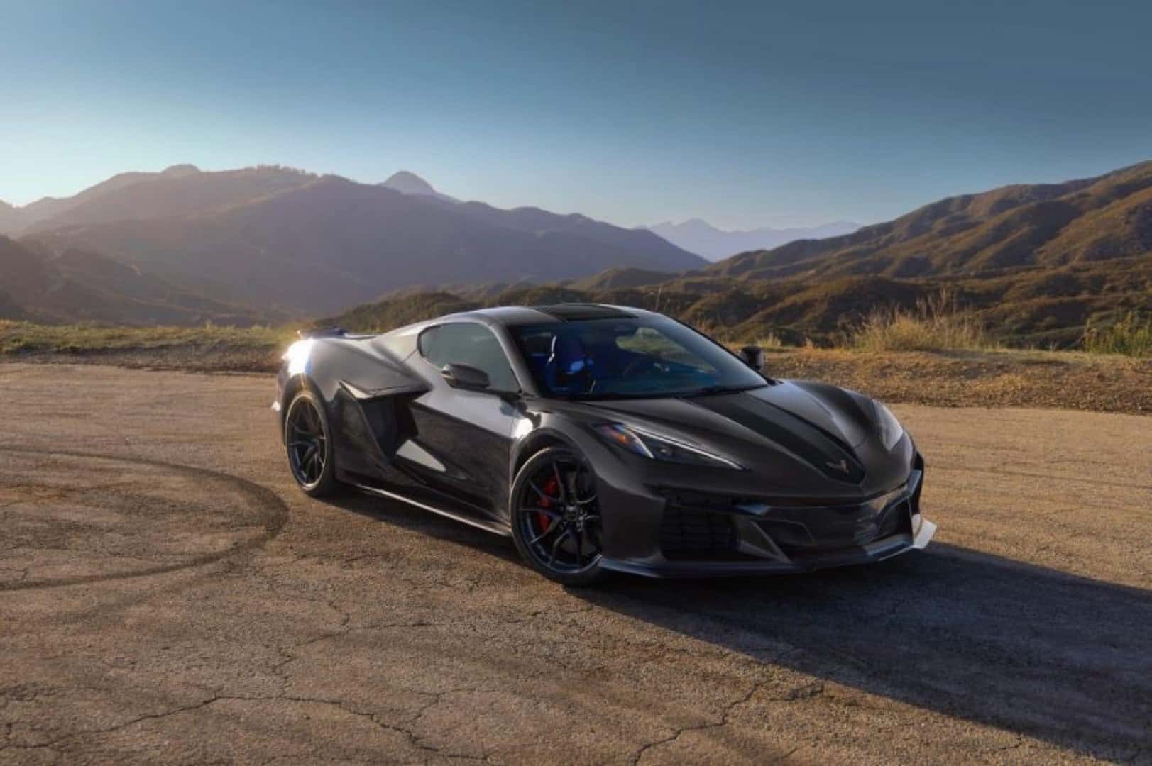 A Black 2027 Chevrolet Corvette Grand Sport X Soaking In The Sun In A Hot, Hilly Landscape