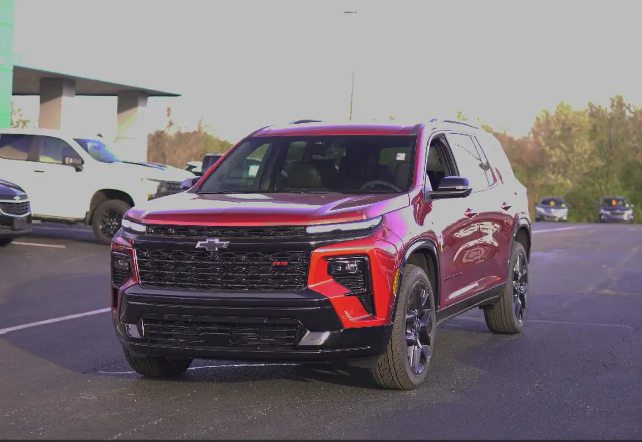 A red Chevrolet Traverse SUV parked on the lot at Barry's Chevrolet dealership in West Union, Ohio