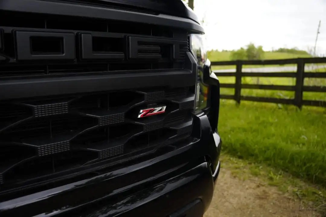 Close-up view of a black truck grille and Z71 emblem, illustrating trim configurations for the gas vs diesel Silverado 1500 comparison