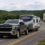 2026 Chevrolet Silverado 2500 HD towing a travel trailer through Adams County Ohio hills on State Route 41
