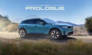 A blue 2024 Honda Prologue EV driving on the road under text Future Vehicle Prologue