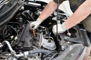 A service technician working on a Honda engine