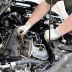 A service technician working on an engine