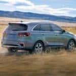 Kia Sorento SUV driving on a dirt road