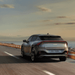 Silver Kia car driving on the road