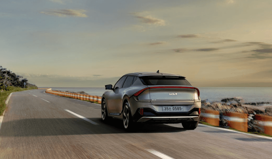 Silver Kia car driving on the road