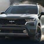 Green 2023 Kia Sorento driving in the dirt