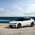 White Kia car on the beach in the summer