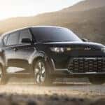 A black 2025 Kia Soul parked on gravel
