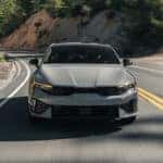 2026 Kia K5 Sedan driving on a mountain road