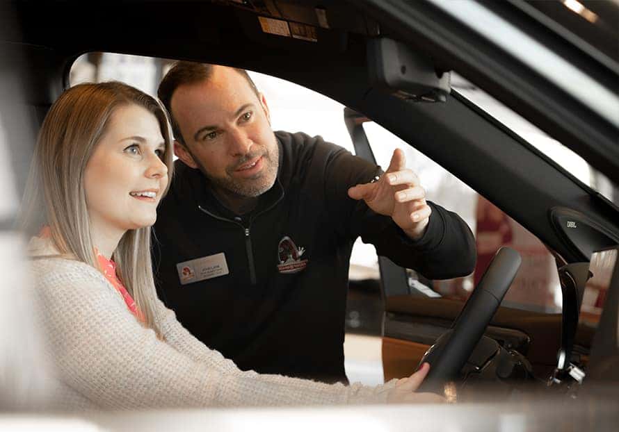 friendly car salesman helping a customer