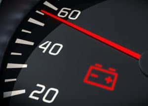 Car dashboard with battery light on