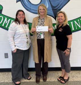 3 ladies holding presentation check for Educators Discount