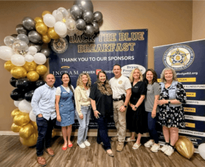 picture of people in front of a backdrop of Fraternal order of Police