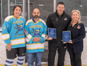 Hockey event people holding plaque