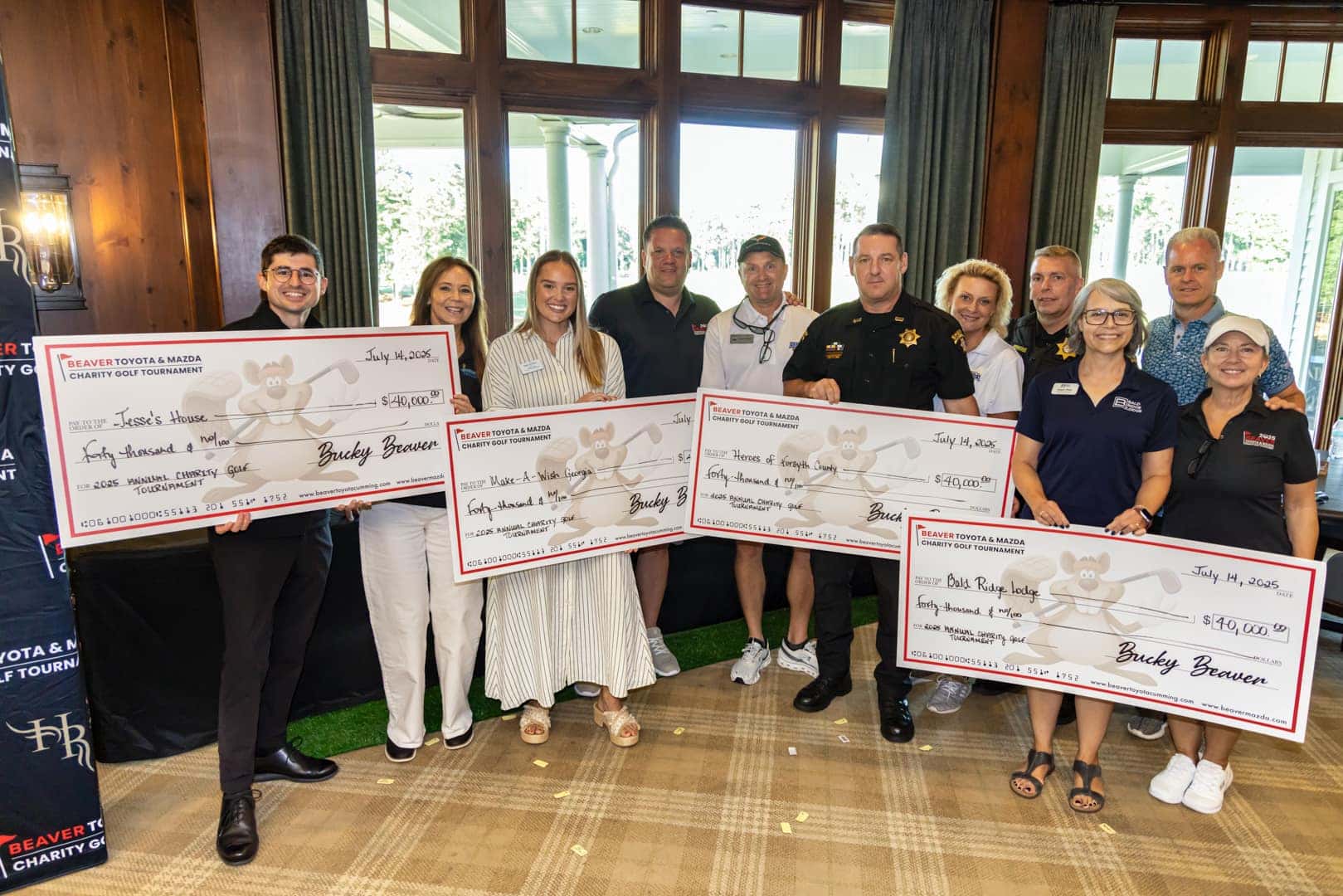 people holding a large charity check