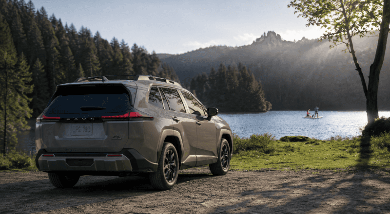 Lakeside RAV4 SUV beneath misty mountains