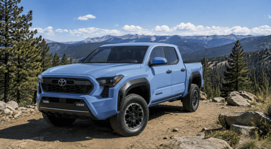 Light blue Toyota Tacoma at a mountain overlook
