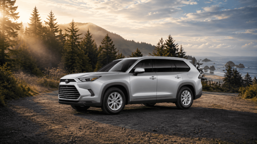 Silver Toyota Grand Highlander SUV by a misty coast