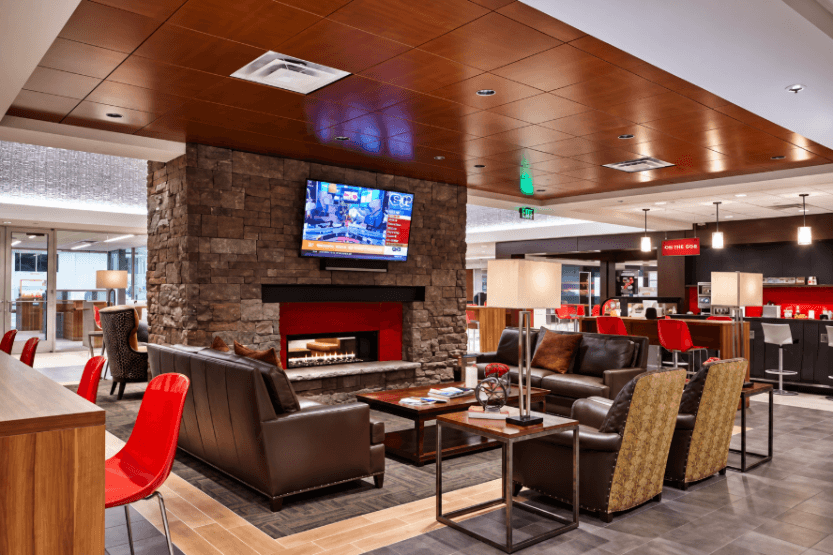 Beaver Toyota of Cumming customer lounge with leather seating, stone fireplace, TV, and cafe area