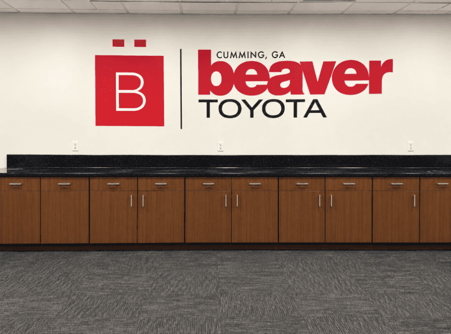 Beaver Toyota of Cumming interior wall with logo and cabinetry