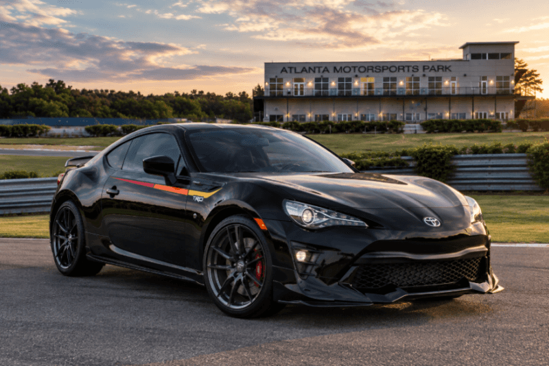 Black Toyota sports coupe parked at Atlanta Motorsports Park during sunset