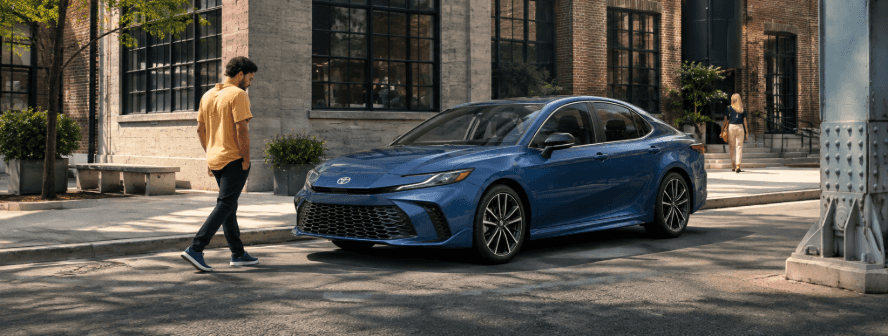 Blue 2026 Toyota Camry shown from a front three-quarter angle on a modern city street