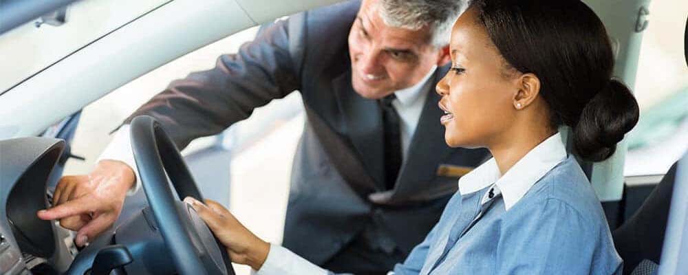 Car salesman and customer in car