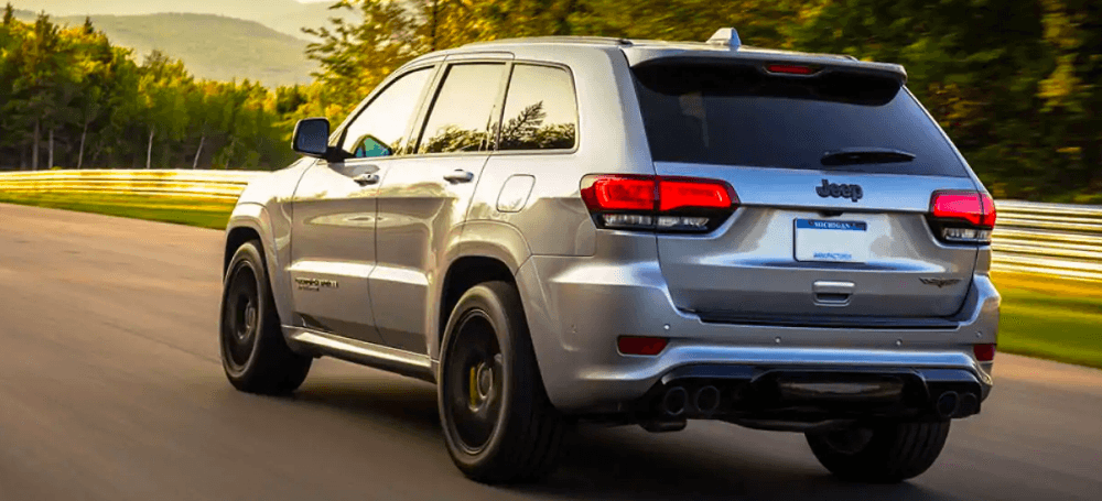 2019 Jeep Grand Cherokee driving at sunset