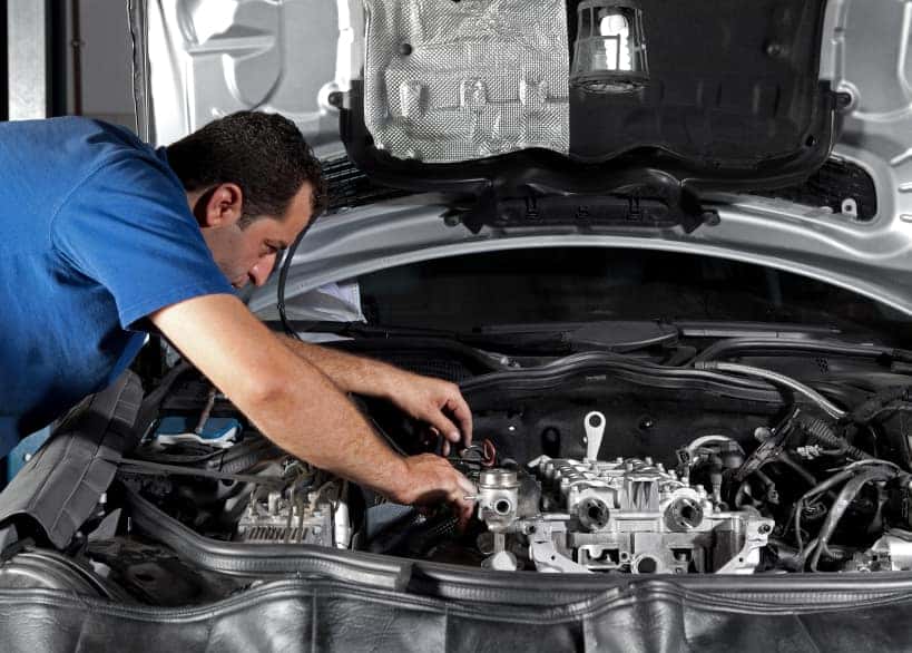 Service technician servicing an automobile battery in the Grove City, OH area