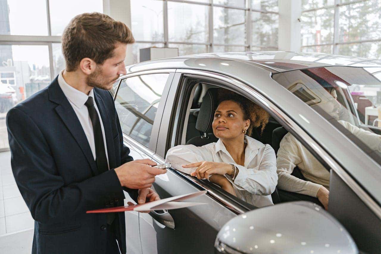 Car Dealer Handing in Keys to a Woman Grove City, OH