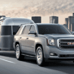 2020 GMC Yukon towing a trailer on city highway