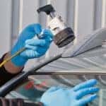Service agent repairs dangerous crack in windshield on location without replacement glass