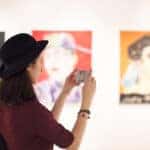 Lady in art museum taking a picture