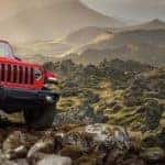Red 2020 Jeep Wrangler off road in mountains