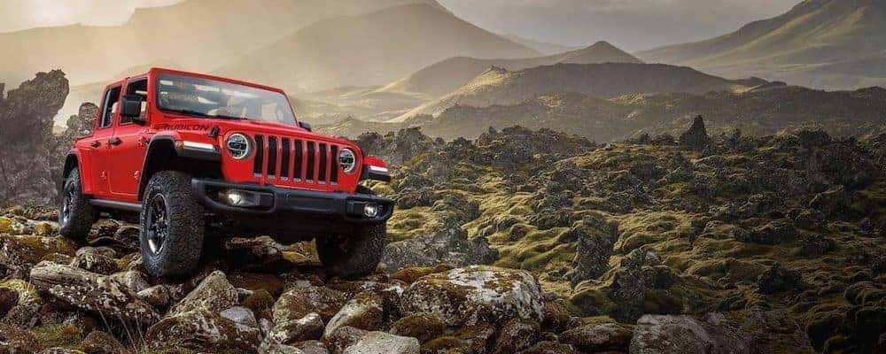 Red 2020 Jeep Wrangler off road in mountains