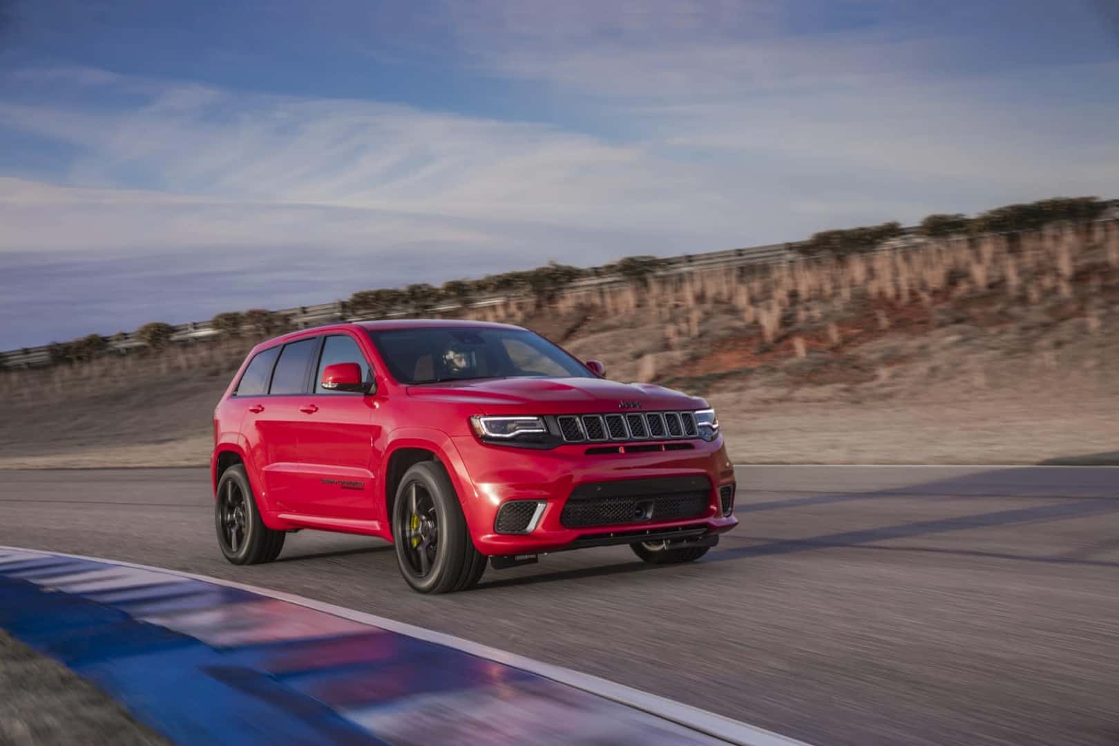 2021 Jeep Grand Cherokee Trackhawk red driving on racetrack