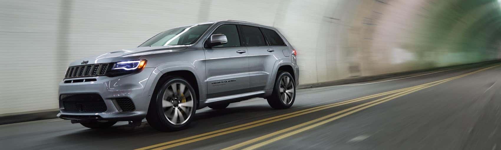2021 Jeep Grand Cherokee silver driving through tunnel